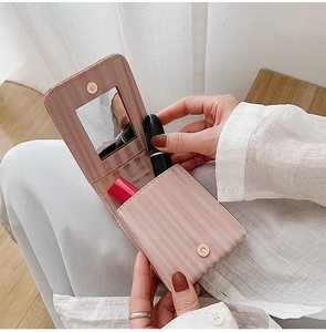 Pink striped leather mini lipstick case with built-in mirror for portable makeup storage