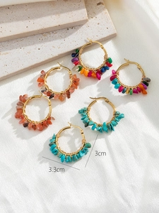 Detail showing 3cm inner diameter of gold bohemian hoop earrings with natural stones