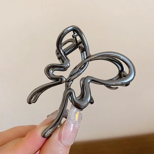 Detailed view of gunmetal butterfly hair claw clip with sleek metallic lines