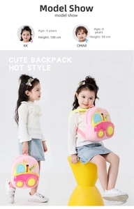 Detailed side view of pink plush toddler backpack featuring a crown and yellow excavator