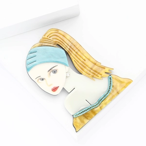 Creative acrylic brooch featuring a blonde girl with blue ribbon on white background