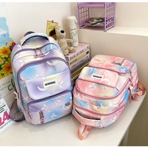 Close-up of pink and purple gradient backpacks with butterfly and moon star patterns