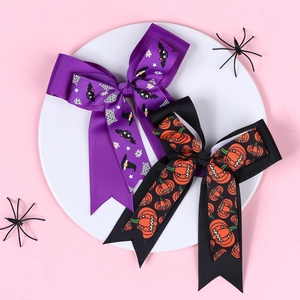 Detail of Halloween hair bows with bat, spider web, and pumpkin patterns for girls