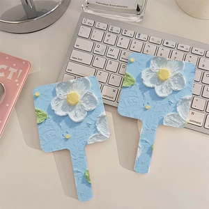 Handheld floral makeup mirror with blue oil painting style white flower handle design