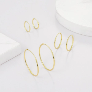 Detailed comparison of three pairs of high-polished gold hoop earrings in various sizes