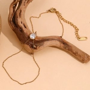Detailed macro view of 18K gold plated double layer bracelet with pear cut drop diamond