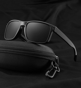 Close-up of classic black cat-eye sunglasses with a textured zipper case and metal hook