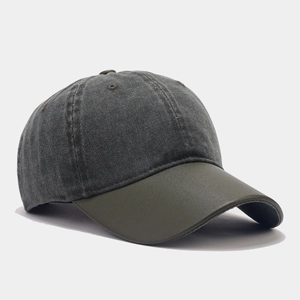 Detail of grey washed denim baseball cap with army green brim and retro six-panel design
