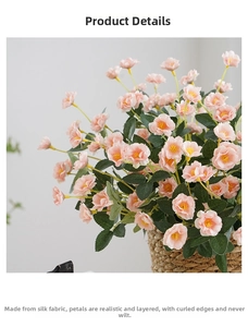 Detail of silk rose bouquet with ruffled petals and green leaves in a woven basket