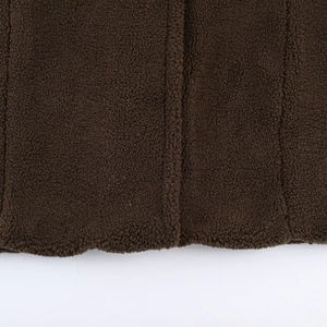 Detailed texture of dark brown fleece jacket fabric with professional vertical stitching