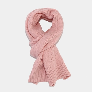 Detail view of the pink cable knit scarf showing soft texture and high-quality yarn material