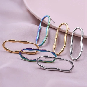 Detailed shot of irregular wavy 304 stainless steel earrings in gold, silver, and rainbow