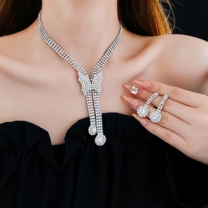 Close-up of sparkling rhinestone heart and butterfly jewelry set worn by a model
