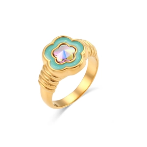 Macro shot of gold floral ring featuring light blue enamel and a prism crystal center