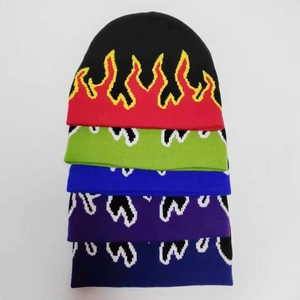 Detailed view of flame pattern jacquard knit beanies in various vibrant colors