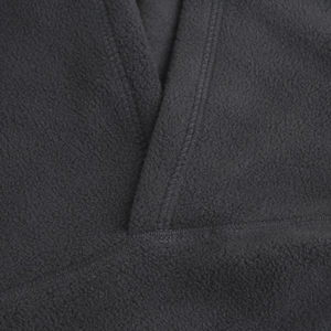 Macro shot of V-neck stitching and thick polar fleece texture on thermal balaclava
