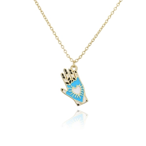 Macro shot of 18K gold plated hand pendant with colorful oil drip heart details