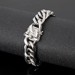 Detail of 16mm silver curb chain bracelet featuring a secure box clasp on a display stand