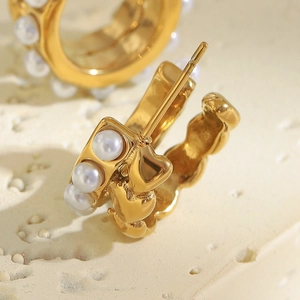 Detailed close-up of 18K gold plated hoop earrings with inset round pearls on stone