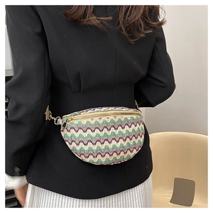 Detail of woven waist bag with colorful wave patterns and adjustable gold zipper strap