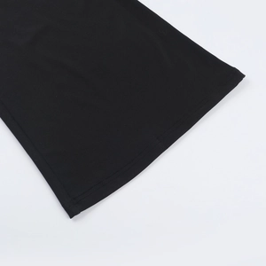 Macro view of professional double-needle stitching and hem detail on black jumpsuits