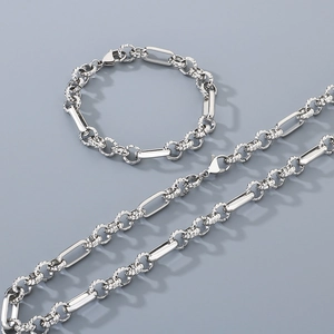 Silver jewelry set with necklace and bracelet featuring unique textured links