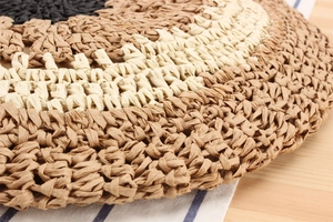 Detailed close-up of handmade round woven paper rope bag featuring tricolor circular patterns