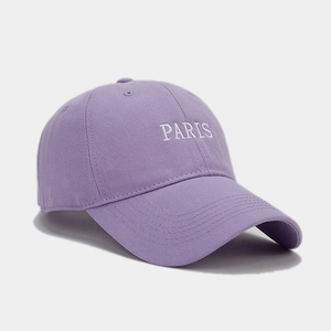 Macro detail of PARIS embroidery on lavender cotton baseball cap with twill texture