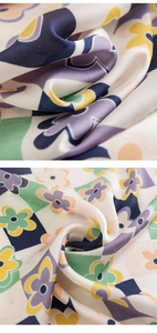 Detail of silk-like scarf fabric with geometric flower patterns and smooth texture