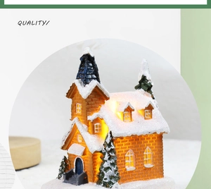 Macro shot of glowing Christmas snow house miniature with warm LED light and snowy trees