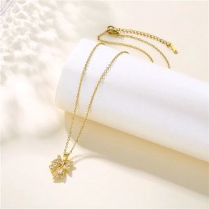 Polished stainless steel gold bow pendant necklace with micro-pave zircon crystals