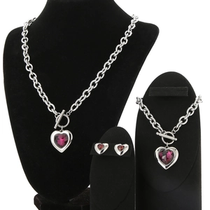 Detailed set of silver chain necklace and bracelet with red crystal hearts on black stands