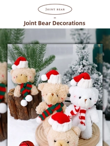 Close-up of plush Christmas bears with festive hats and striped scarves on snowy wood
