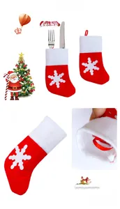 Close-up of mini Christmas stocking cutlery holder with white snowflake and plush trim