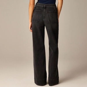 Detail of high waist and back pocket stitching on loose wide leg denim trousers