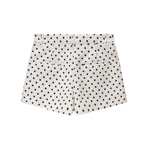 Detail view of white high-waisted shorts with black polka dots and decorative back pockets