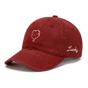 Detail of burgundy washed cotton baseball cap with four-leaf clover and Lucky embroidery