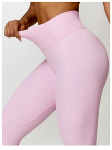 Detail shot of pink high-waist yoga pants showing high-stretch performance fabric