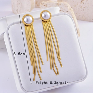 Detail of 8.5cm long gold metal tassel earrings with pearls and snake chains