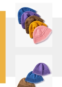 Detail view of colorful knit beanies with contrasting white handmade stitching and ribbing