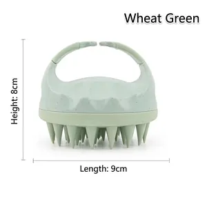 Detail view of wheat green silicone scalp massager brush showing ergonomic handle and bristles
