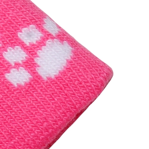 Close-up of pink knitted fabric showing detailed white paw print jacquard texture