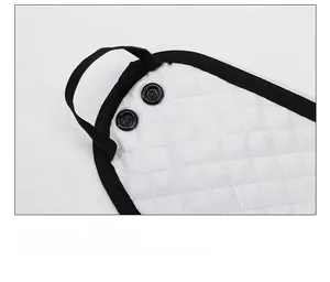 Close-up of quilted fabric with black snap buttons and elastic strap for secure fit