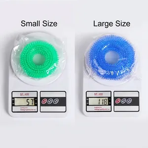 Durable TPR spiked ring dog chew toys in small green and large blue sizes on scales