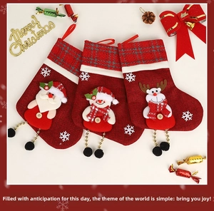 Detail of Christmas stockings with Santa, Snowman and Reindeer patterns and bead charms