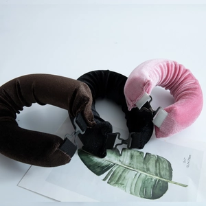 Three velvet heatless hair rollers in brown black and pink with adjustable hooks