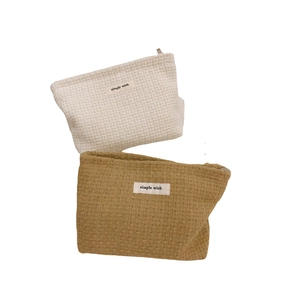 Minimalist waffle woven makeup bags in cream and yellow with simple wish label