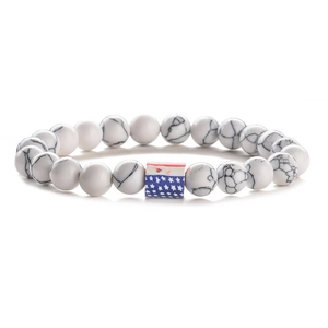 Detail of white turquoise beaded bracelet featuring a United States flag barrel bead