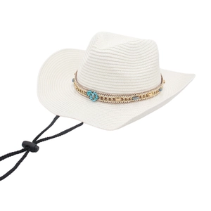 Detail of bohemian turquoise band and woven straw texture on white cowboy hat