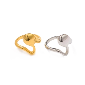 Detail showing irregular gold and silver fluid geometric rings with polished surface